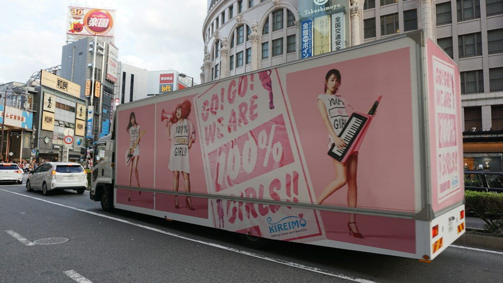 Vibrant pink truck with eye-catching mobile billboard advertising.